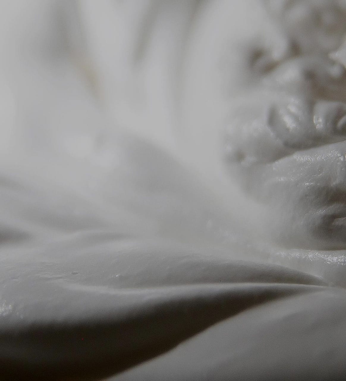 soft white tallow cream texture with blurred background, behind Mirath FAQ heading 'We thought you might ask'