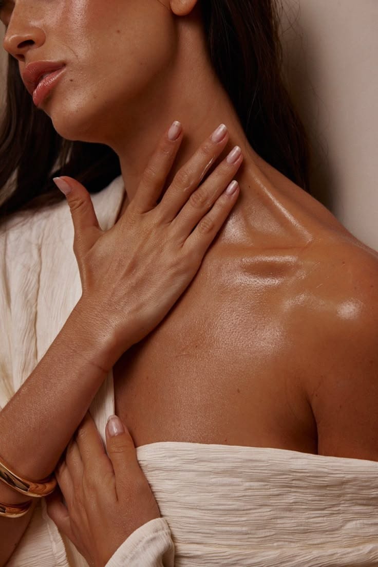 Woman applying Mirath beauty tallow moisturizer on her neck and décolletage — skin glowing as the tallow balm absorbs effortlessly, nourishing and sinking in naturally without heaviness.