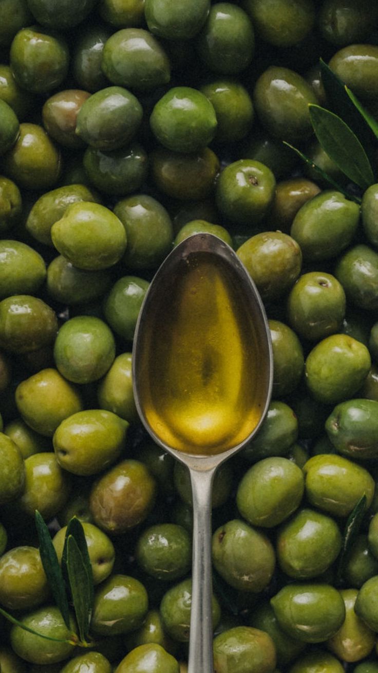 Close-up of olives and olive oil, representing high phenolic olive oil, ancestral and traditional skincare ingredient from Lebanon, known as liquid gold for nourishing skin