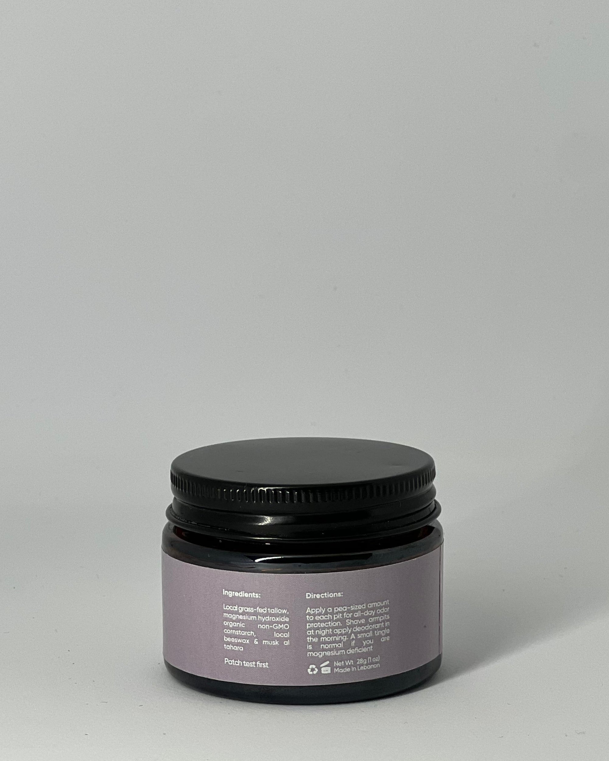 Back view of natural tallow deodorant jar  by Mirath Beauty showing ingredients, directions, and clean magnesium-based formula with grass-fed tallow for odor protection scented with musk al-tahara, made in Lebanon 