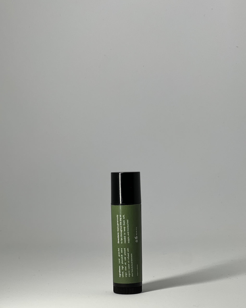 Back of tallow lip balm by Mirath Beauty, showing ingredients: grassfed tallow, olive oil, castor oil, beeswax, directions and clean unscented formulation for lip repair made in Lebanon