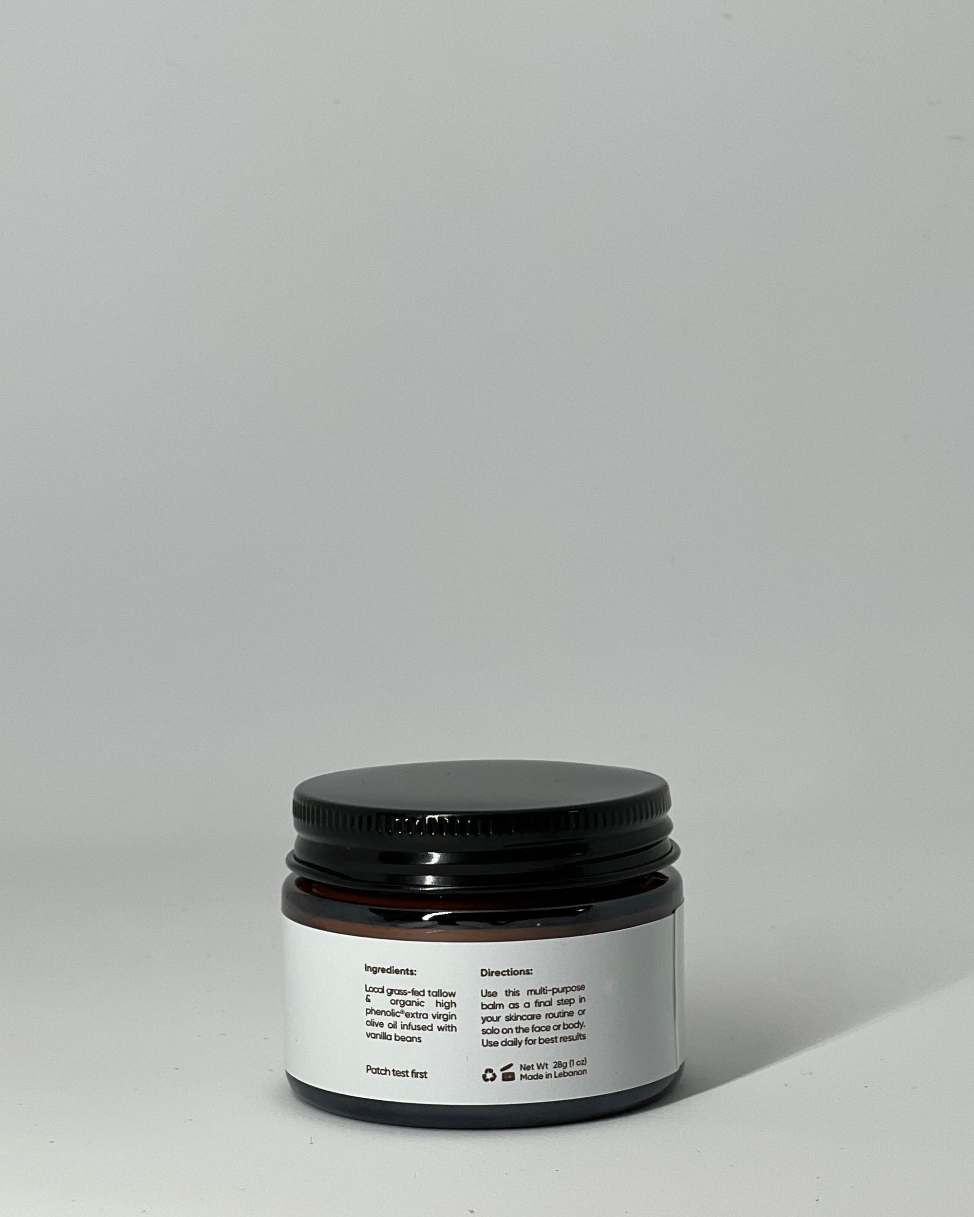 back view of The Simple One tallow cream jar showing ingredients: grass-fed tallow and high-phenolic olive oil, usage directions, patch test warning, net weight, recyclable packaging, and made in Lebanon - all-purpose skincare by Mirath Beauty.