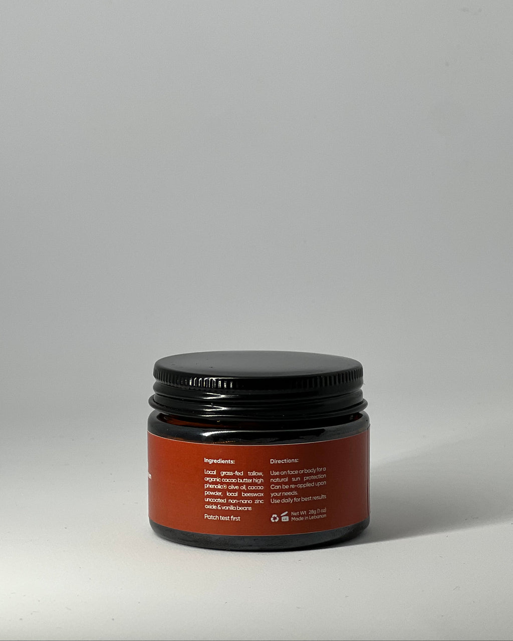 back view of the sun cream tallow mineral sunscreen jar with ingredient list: grassfed tallow, non nano zinc oxide and nourishing butters, with directions, patch test warning, recyclable packaging, made in lebanon