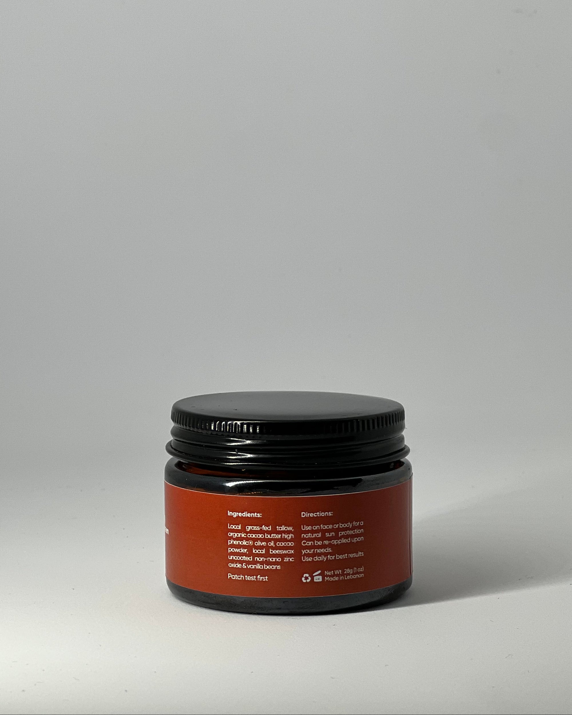 back view of the sun cream tallow mineral sunscreen jar with ingredient list: grassfed tallow, non nano zinc oxide and nourishing butters, with directions, patch test warning, recyclable packaging, made in lebanon